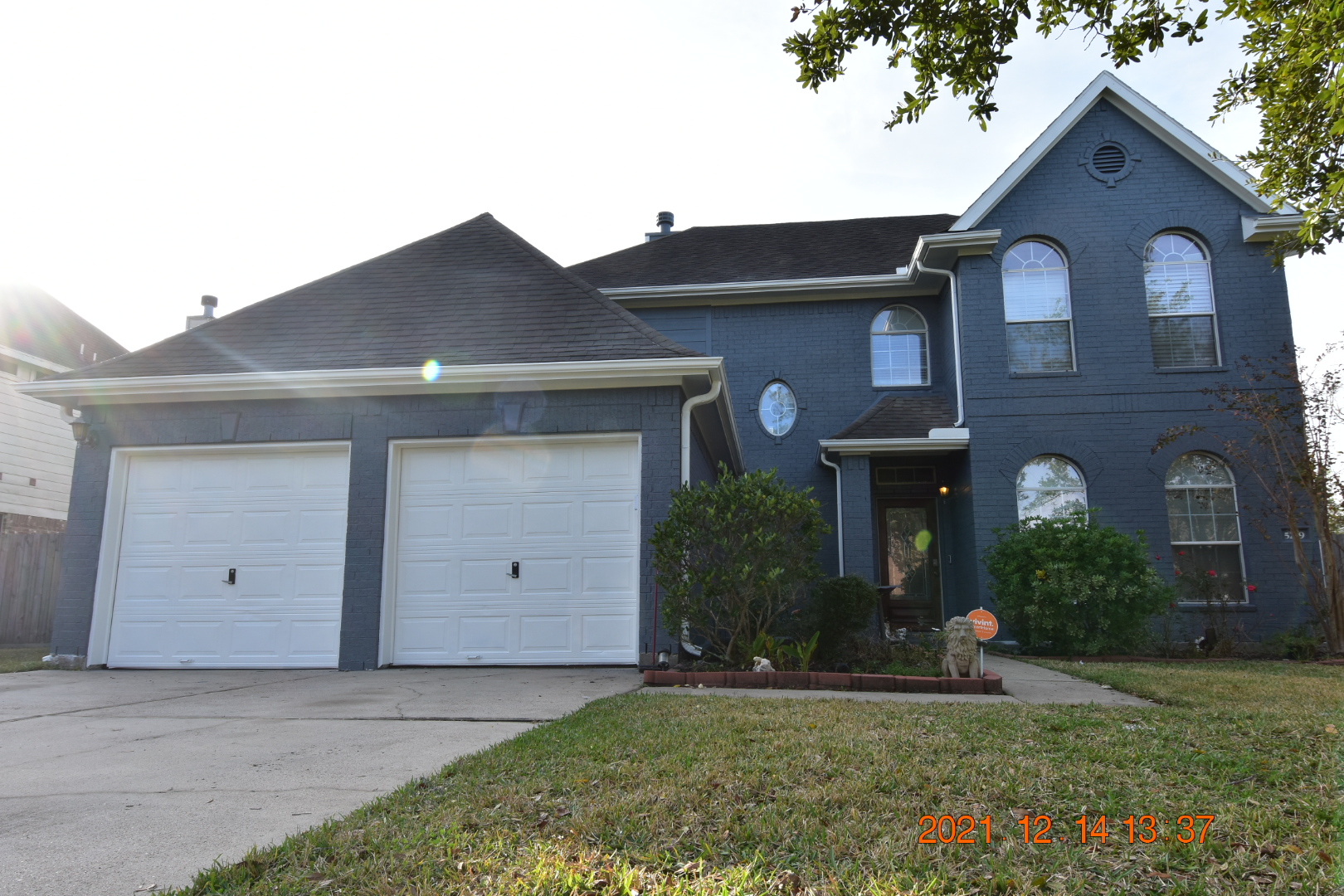 After — same home with freshly painted blue-gray brick exterior in the Baytown area