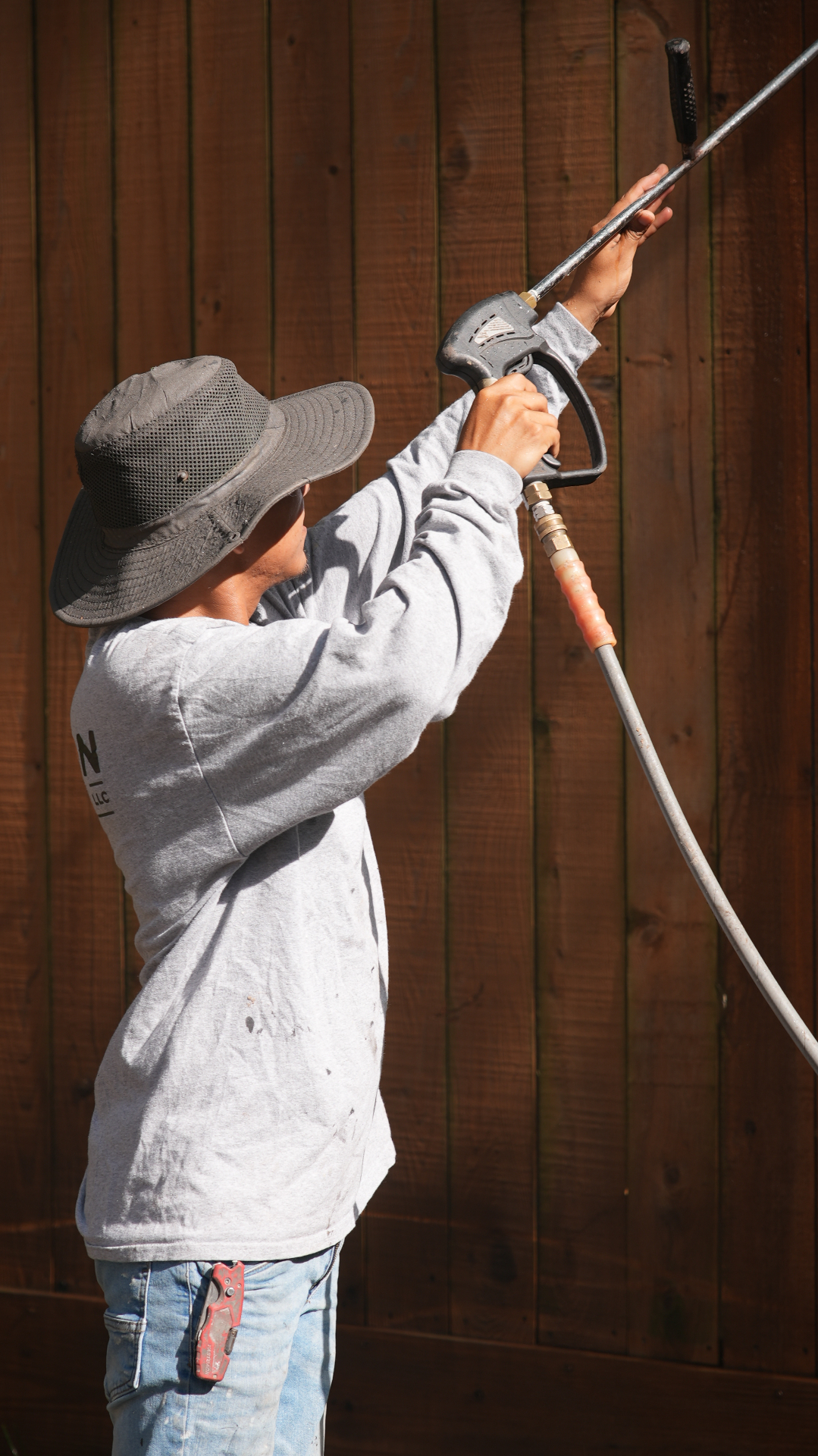Pressure washing a wood fence before staining