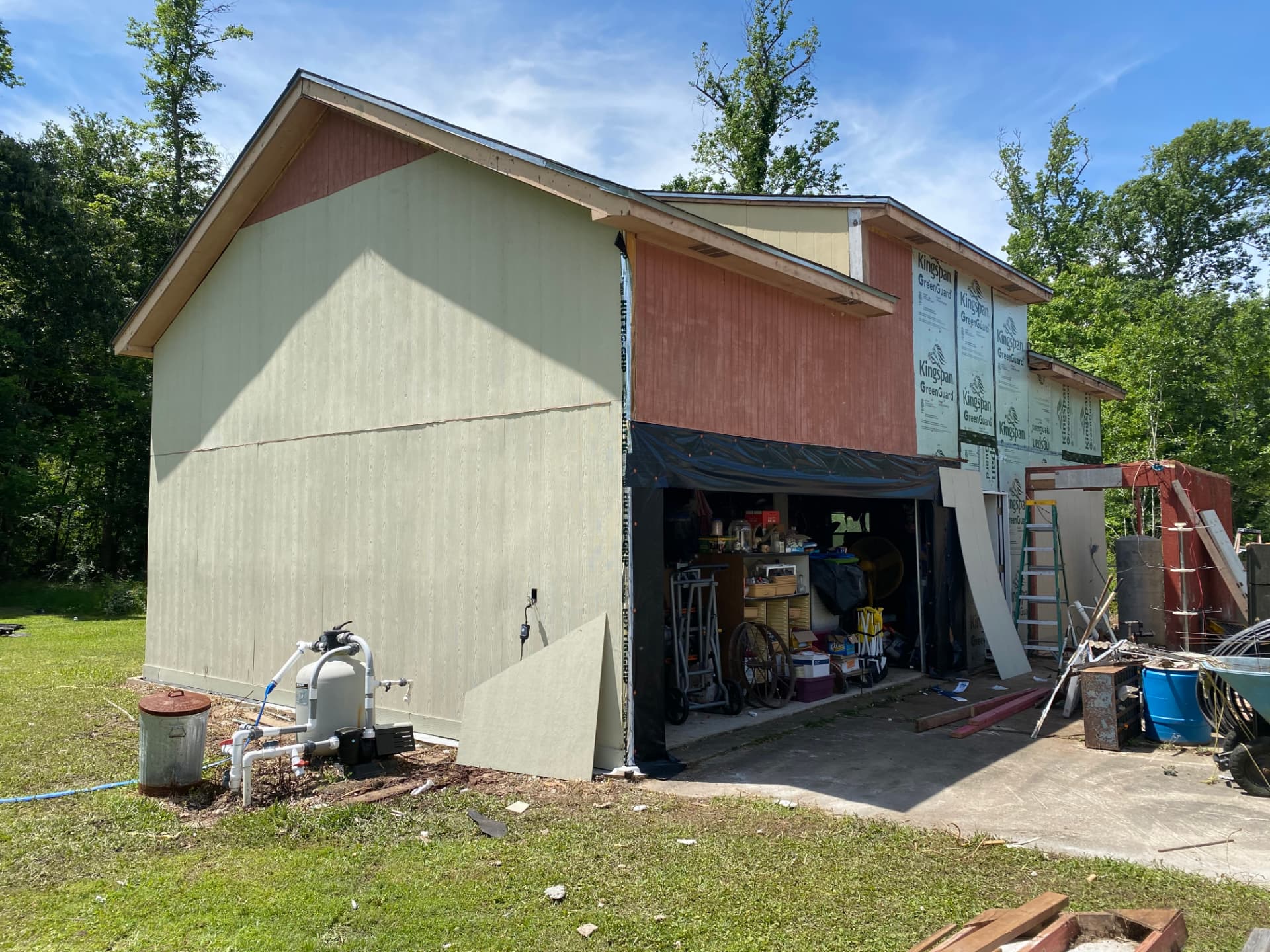 Before — unpainted barn and garage exterior in the Baytown area