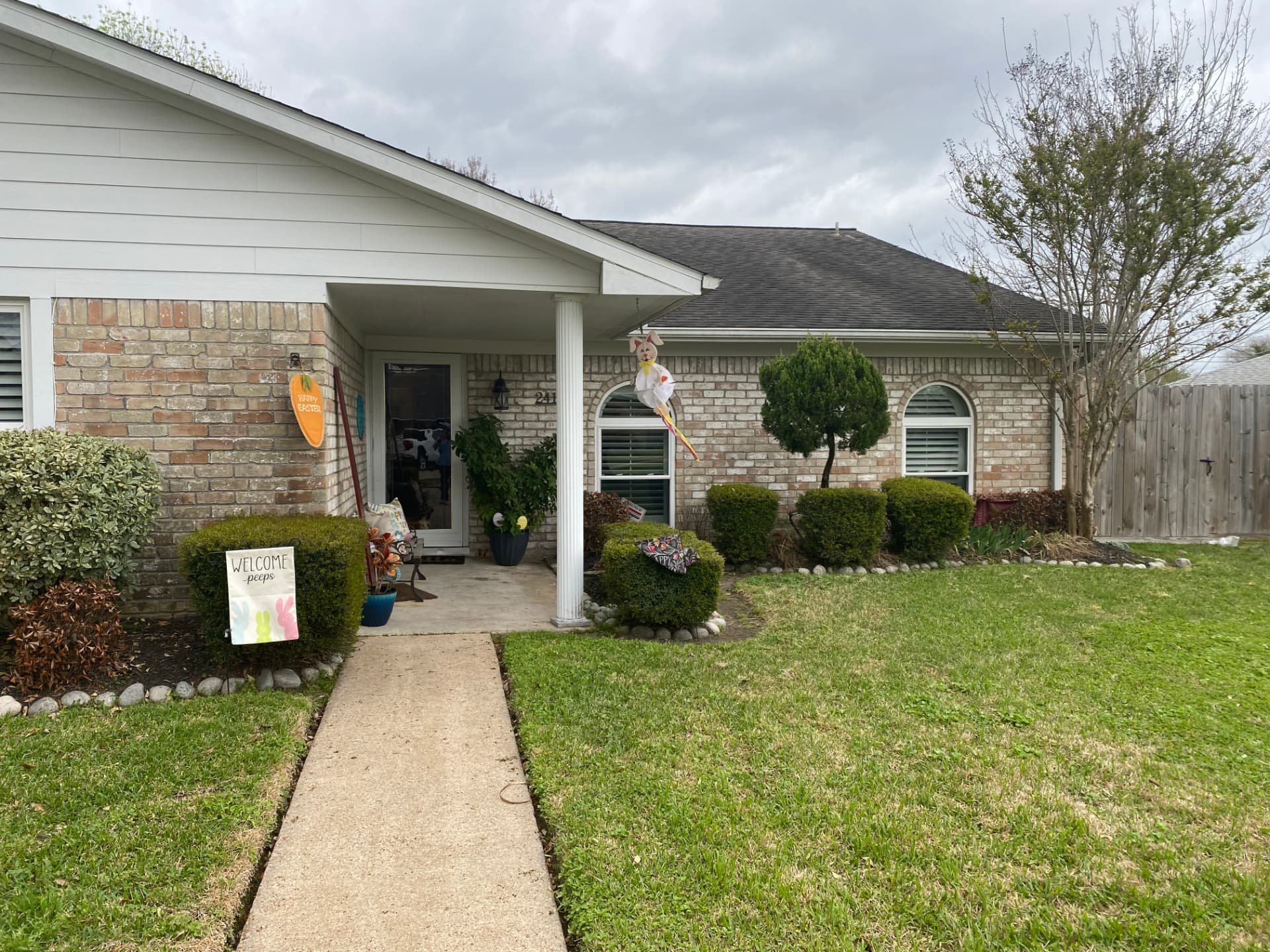Before — natural brick home exterior before professional painting in the Baytown area