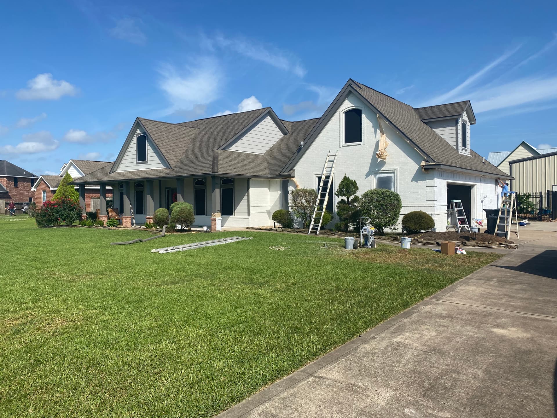 After — same home with fresh white exterior paint in Baytown, TX