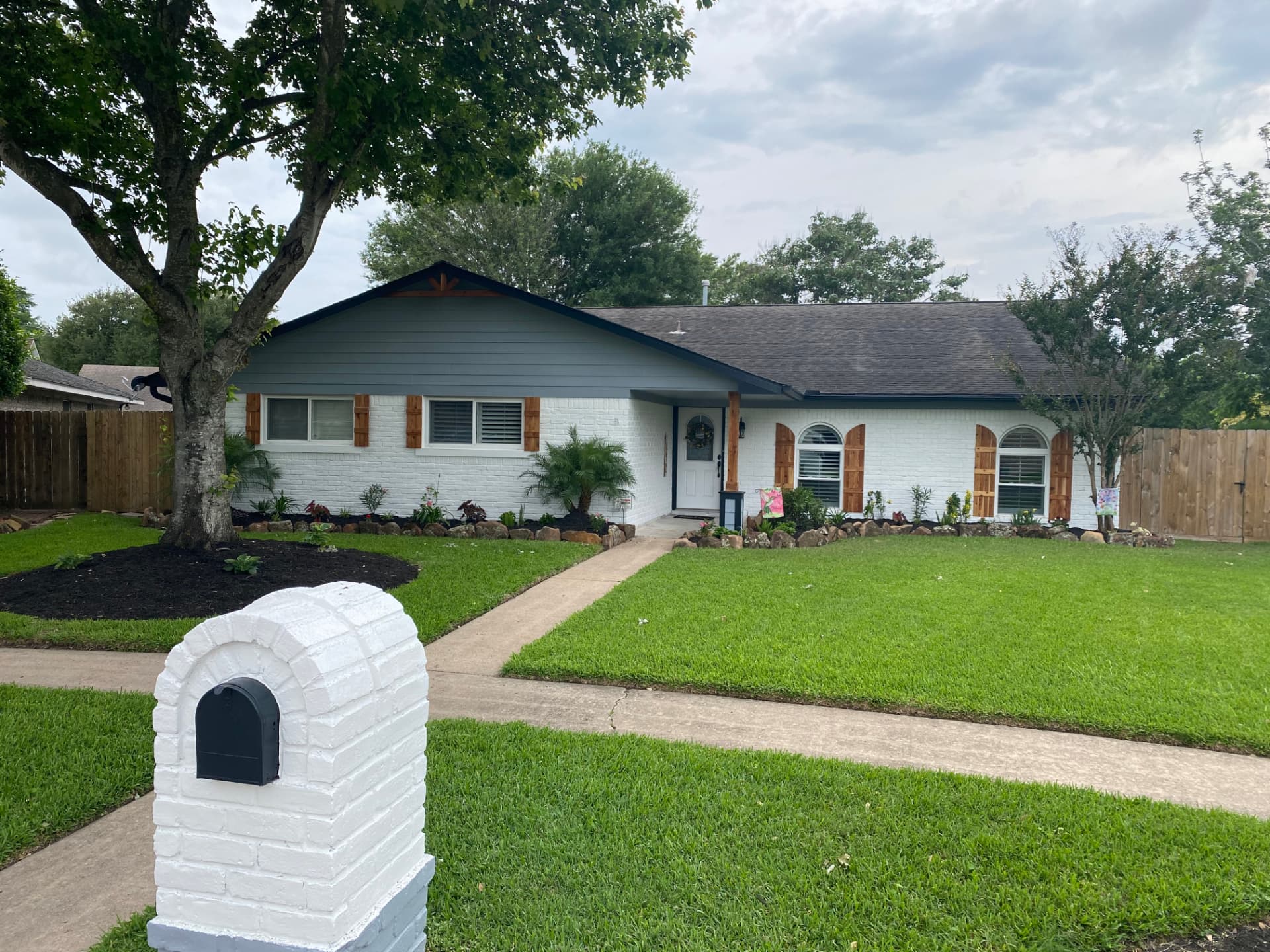 After — same home with freshly painted white brick exterior in the Baytown area