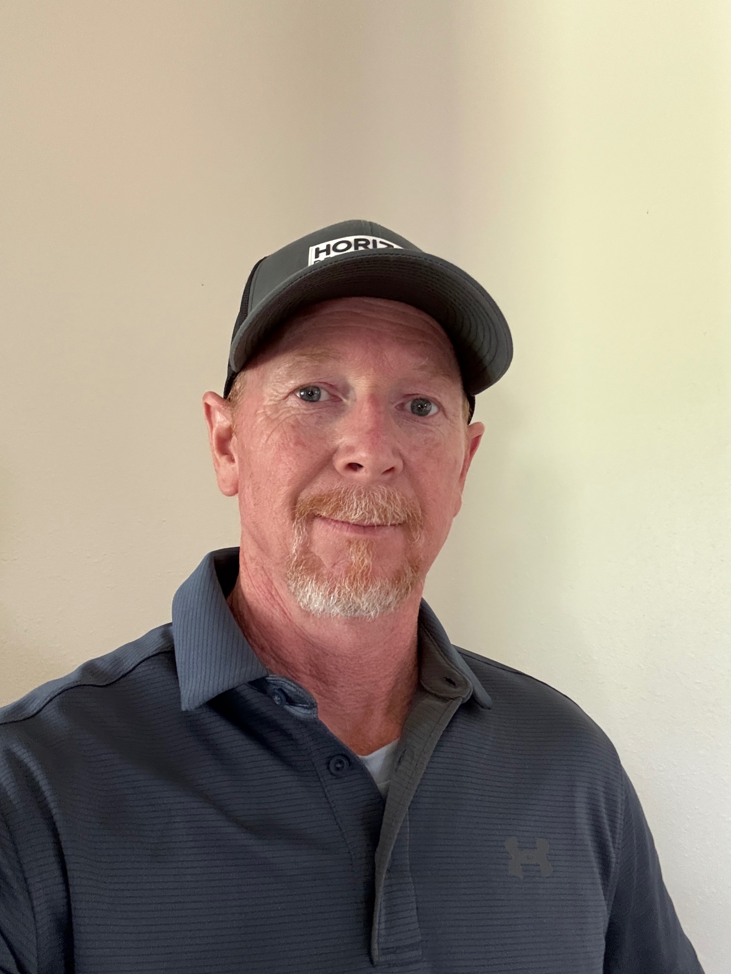 Owner of Horizon Restoration LLC in a company hat and polo, serving the Baytown and Houston area
